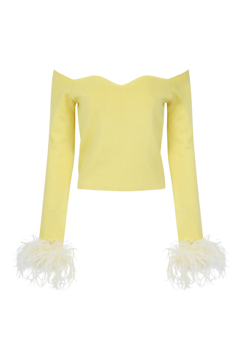 Andreeva yellow vanilla knit top with feather cuff accents, featuring a cozy fit and stylish detachable feather cuffs.