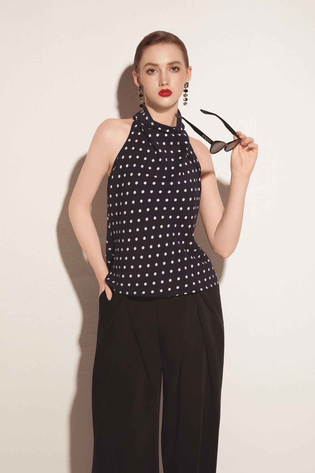 Black Valenciani wide leg trousers with relaxed fit and high waist, shown on a model against a neutral background.