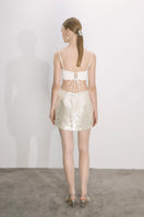 Nazlı Ceren cloud cream sequin A-line mini skirt, stylish and shiny, shown on a model with a high waist and playful design.