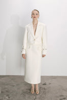 Nazlı Ceren vanilla ice satin cropped jacket with long sleeves and collar, styled on a model for a fashion photoshoot.