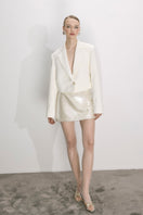 Nazlı Ceren cloud cream sequin mini skirt featuring an A-line silhouette and shimmering embellishments.