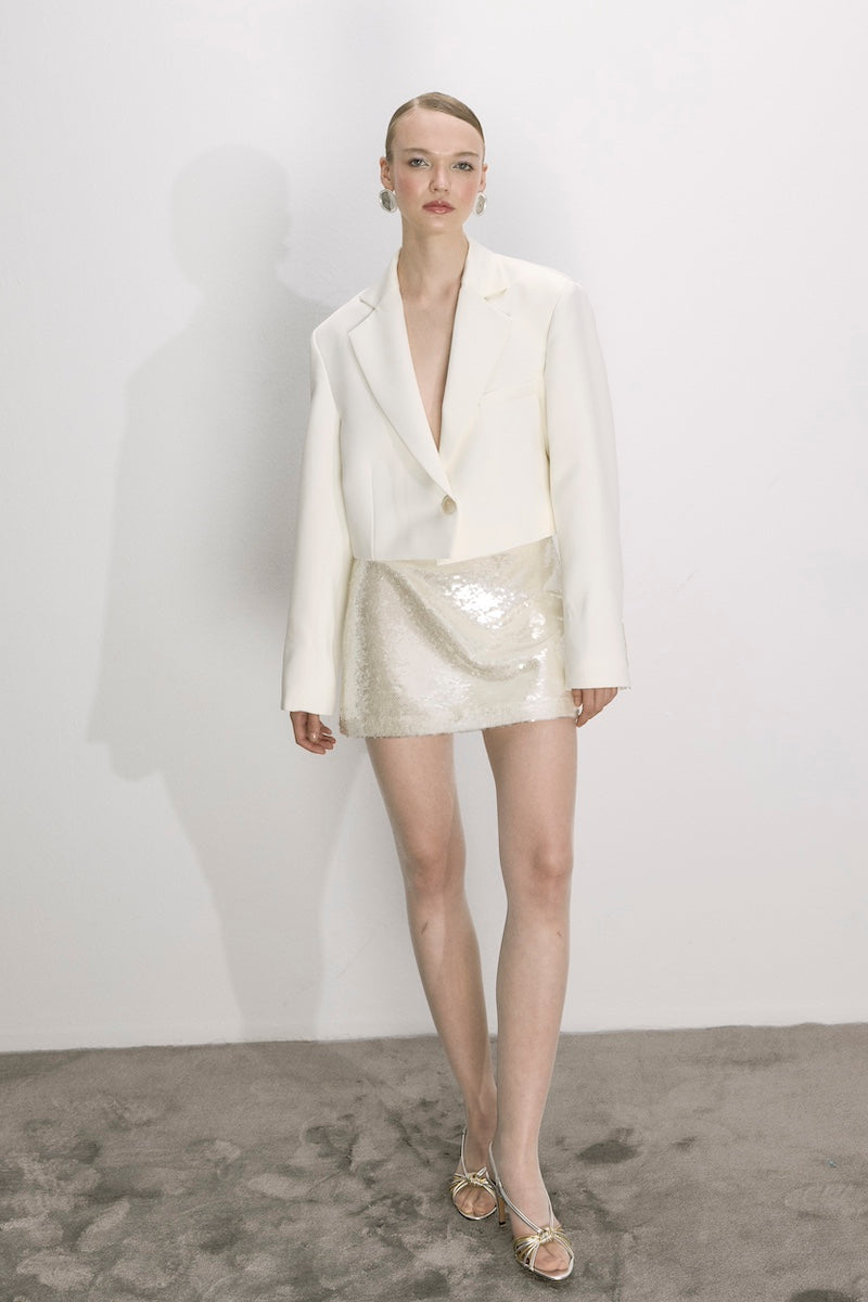 Nazlı Ceren vanilla satin cropped jacket with long sleeves and a sleek, modern design, displayed on a white background.