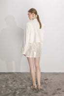 Nazlı Ceren cloud cream sequin mini skirt in A-line style with shimmering embellishments, perfect for stylish evening wear.