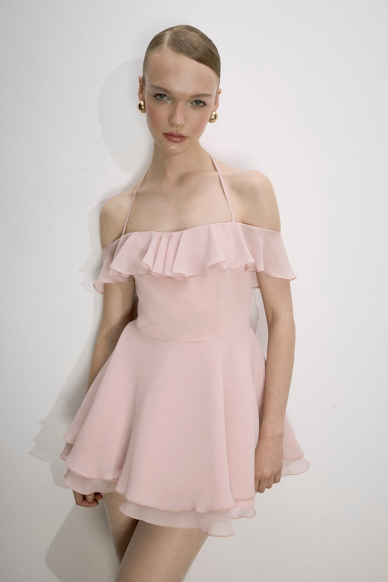 Nazlı Ceren Evie Mini Dress in tender peach, sleeveless with a fitted silhouette, styled on a model.