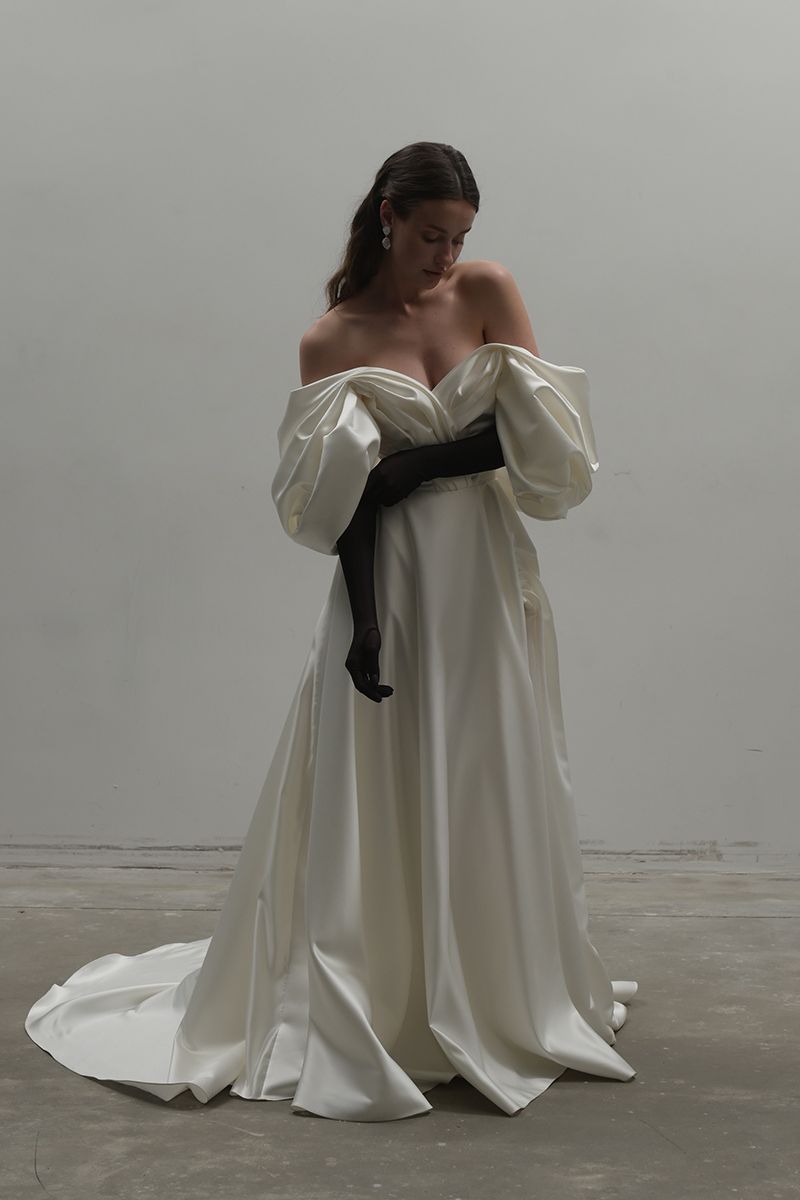 Off-White volume sculpted gown by Monetre, featuring a flowing design with structured detailing and a sophisticated silhouette.