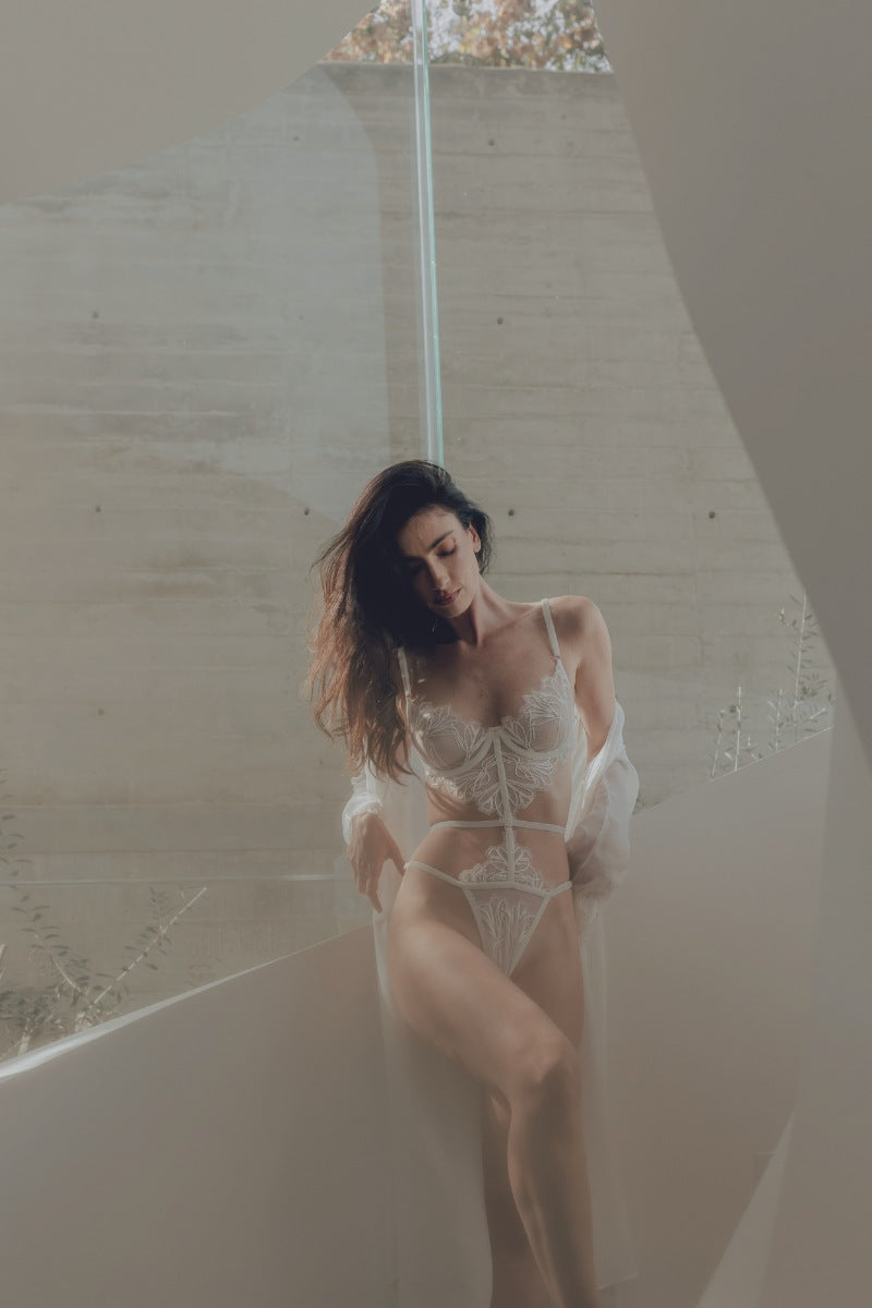 White Lily bodysuit from Entos lingerie set featuring a fitted design and delicate fabric, shown on a model.