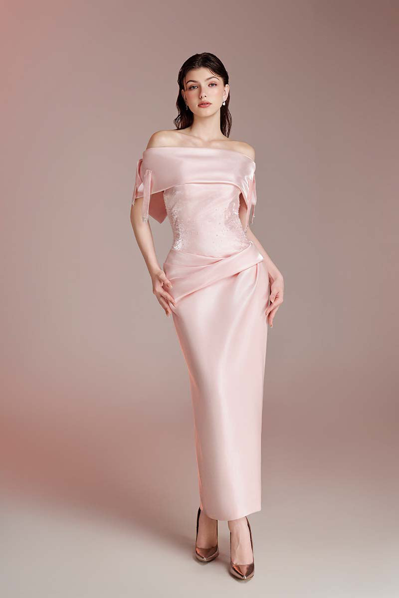 Do Long Elysian Muse pink gown laid out on a flat surface, showcasing its flowing fabric and elegant design.