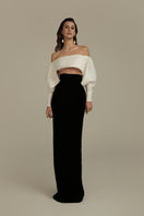 EVELORA gown by POEM in black and white, featuring elegant flowing fabric and sophisticated design, perfect for formal occasions.