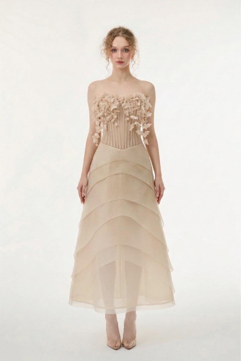 Beige tulle and organza gown by 21Six, featuring a flowing design with elegant fabric details and a sophisticated silhouette.