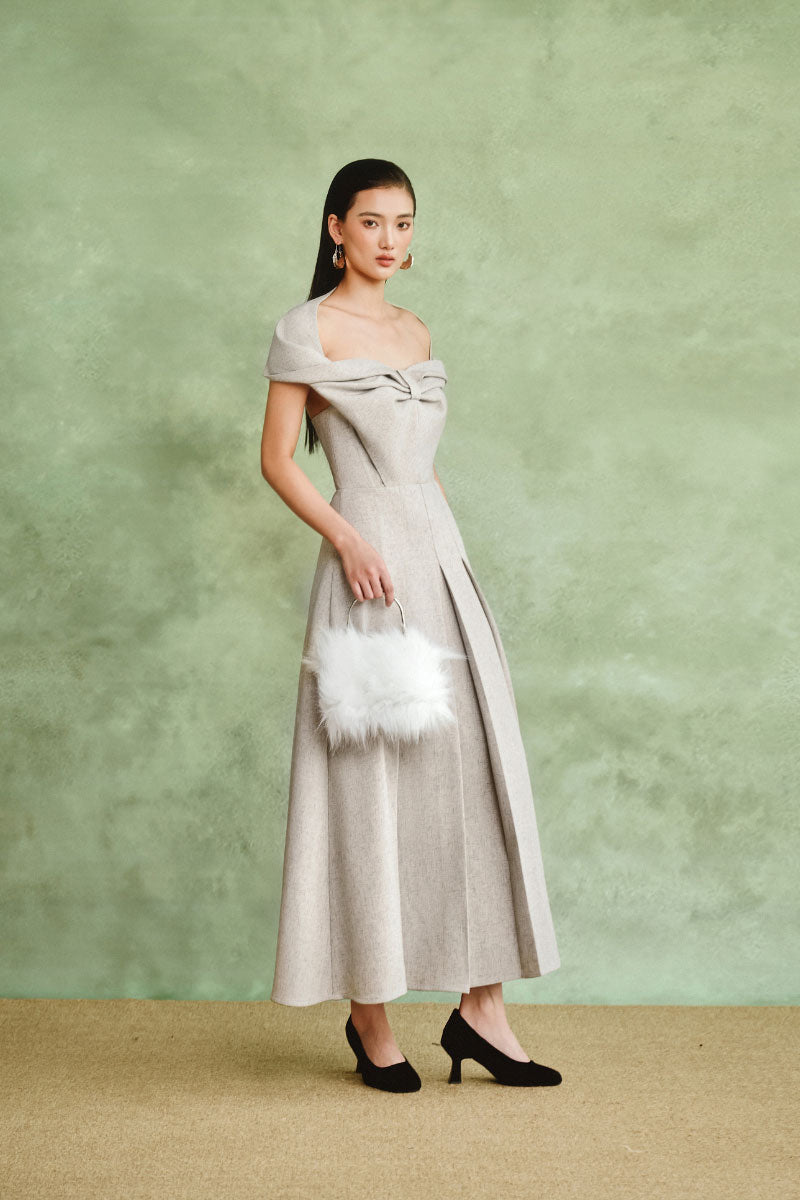 Gray off-shoulder pleated midi dress by White Plan, featuring a flowing fabric and elegant design, shown on a model.