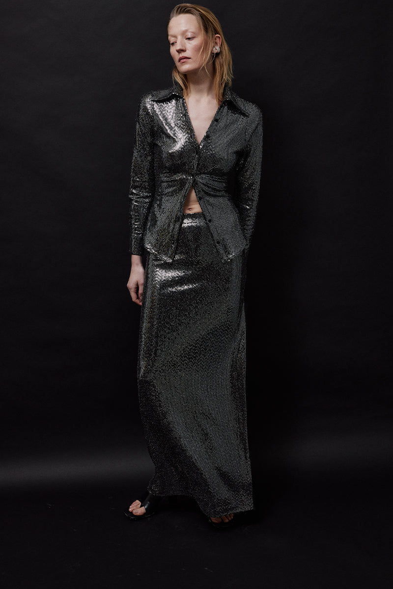 TAGG metallic mid-rise maxi skirt with a flowing design, featuring a shiny metallic fabric and a comfortable waistband.