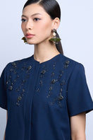 A pair of green dew drop earrings from Aidan & Ice, featuring elegant glass teardrops hanging from silver hooks.