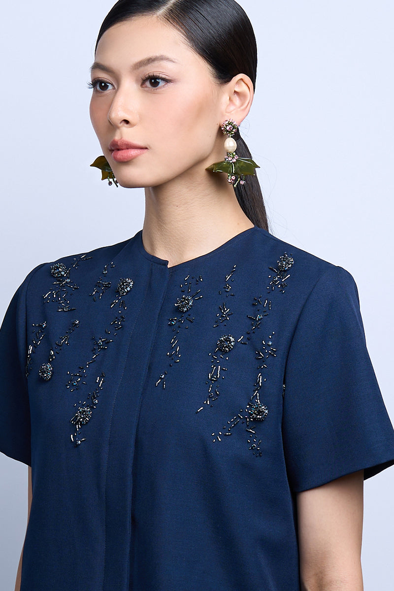A pair of green dew drop earrings from Aidan & Ice, featuring elegant glass teardrops hanging from silver hooks.