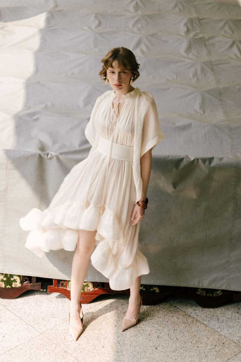 White Plan Gabriella Mini Dress displayed on a hanger, featuring a stylish design with a fitted silhouette and trendy details.