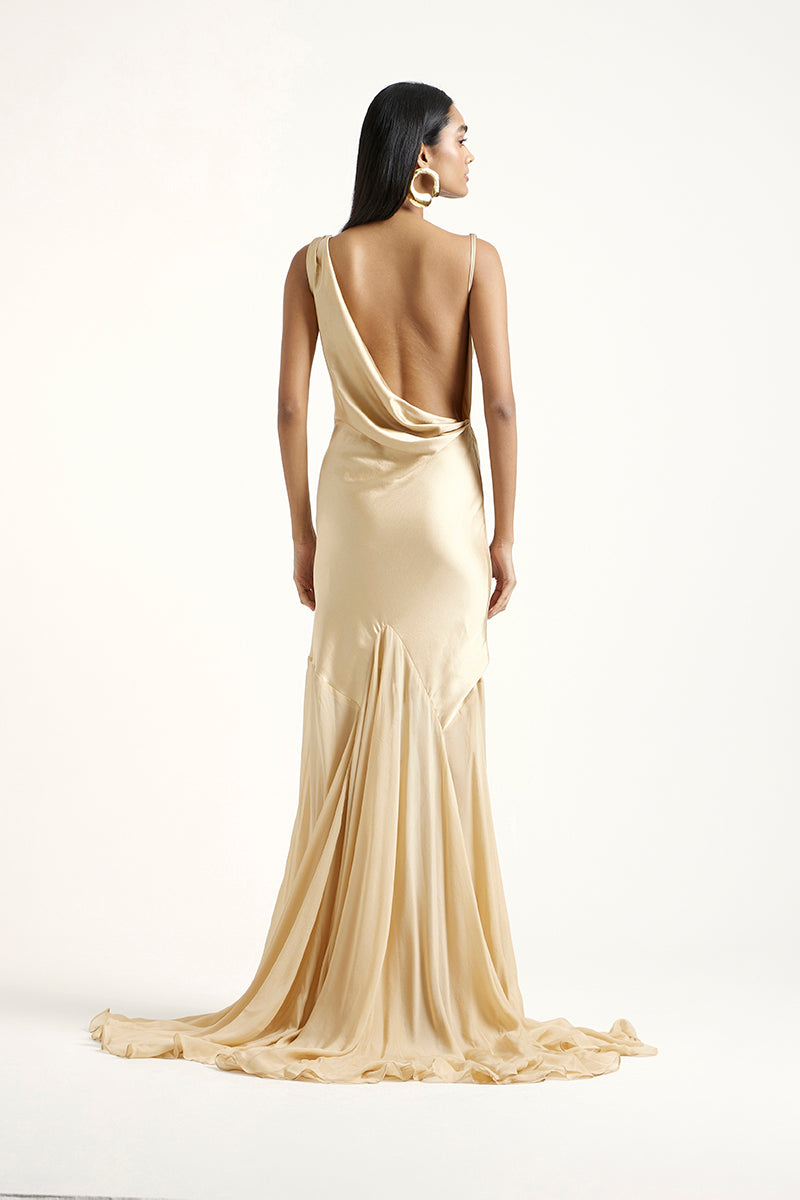 Deme By Gabriella Collen Gold gown featuring elegant fabric and a flowing design, perfect for formal occasions.