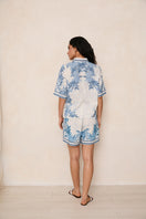 Raishma Ethel shirt featuring a stylish design, displayed on a hanger with a close-up of fabric and pattern details.