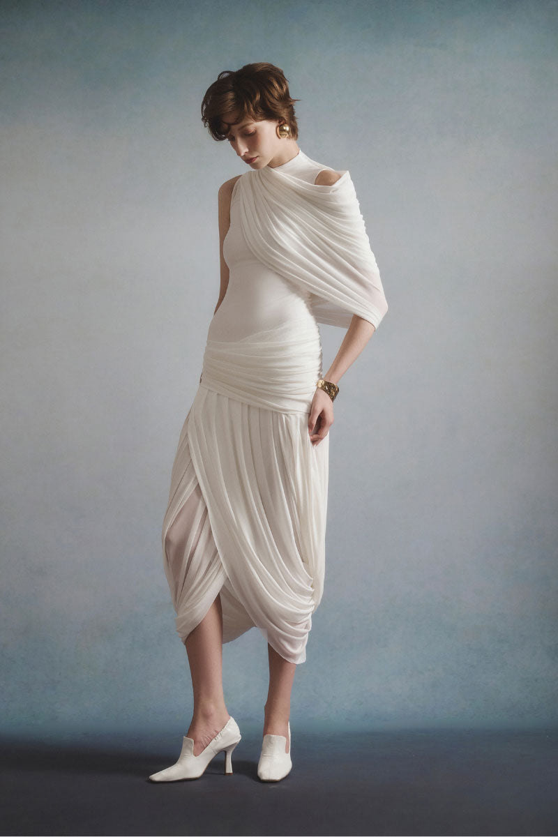 White Plan Lumière draped midi dress shown on a mannequin with flowing fabric and elegant design.