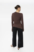 Dāl the Label modal asymmetric knit top featuring a unique draped design and soft, lightweight fabric in neutral tones.