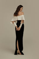 Elegant black and white EVELORA gown by POEM, featuring flowing fabric and stylish design for formal occasions.