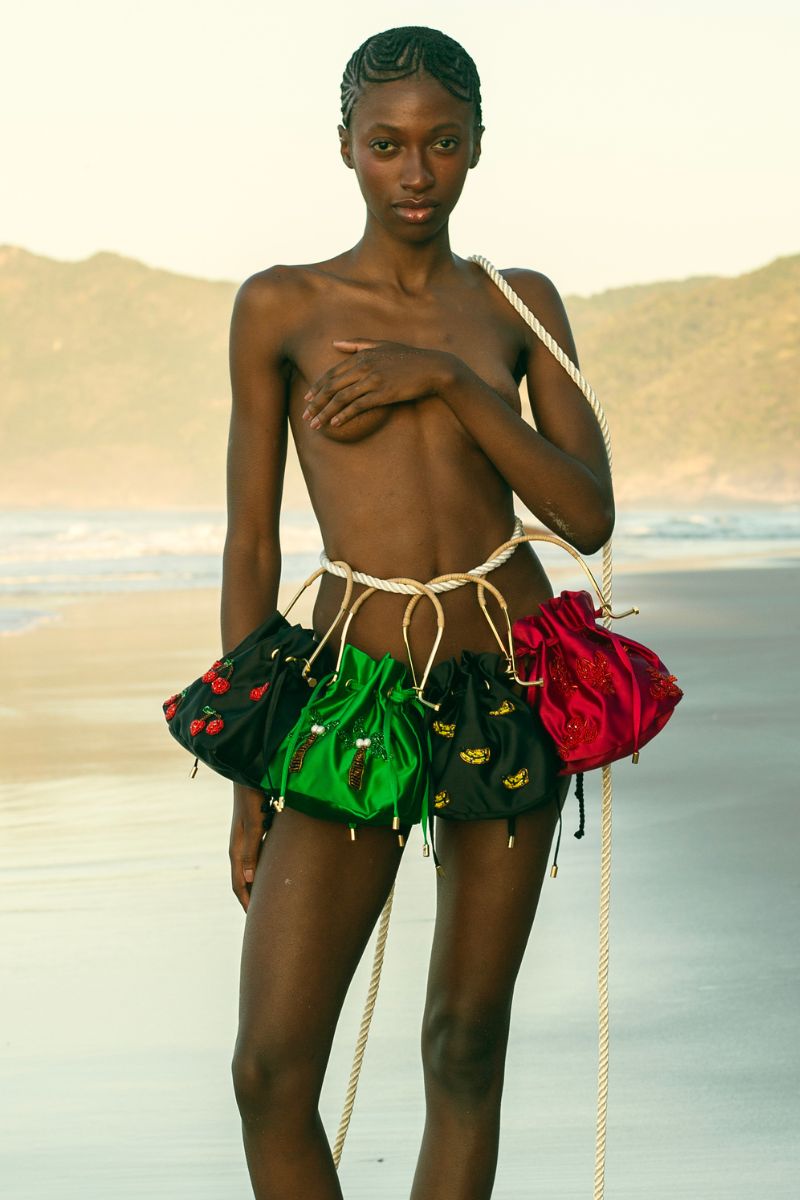 Waiwai Rio BEL CETIM cherry top handle bag with a structured design and gold-tone hardware, stylish for casual or formal wear.