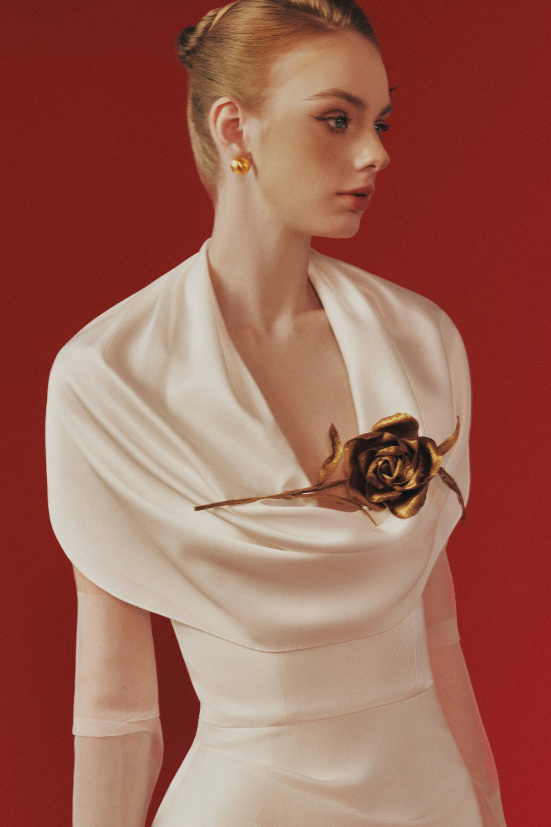 Margée Atelier Celina Maxi Dress displayed on a model, featuring a flowing silhouette and elegant design in a natural setting.