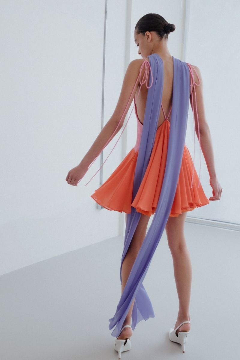 Sisters Kimberly mini dress in peachy pink, sleeveless style with a fitted silhouette, perfect for summer or casual occasions.