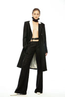 Vaska black double-breasted coat with white collar, tailored coat with lapels and buttons, stylish outerwear for cold weather.
