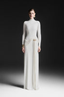 White Corvina draped floor-length gown by Maison Des Copains, elegant evening dress with flowing fabric and sophisticated style.