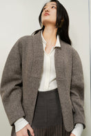 Light blue boxy collarless jacket by LECIA, featuring a modern, minimalist design and clean lines, displayed on a neutral background.