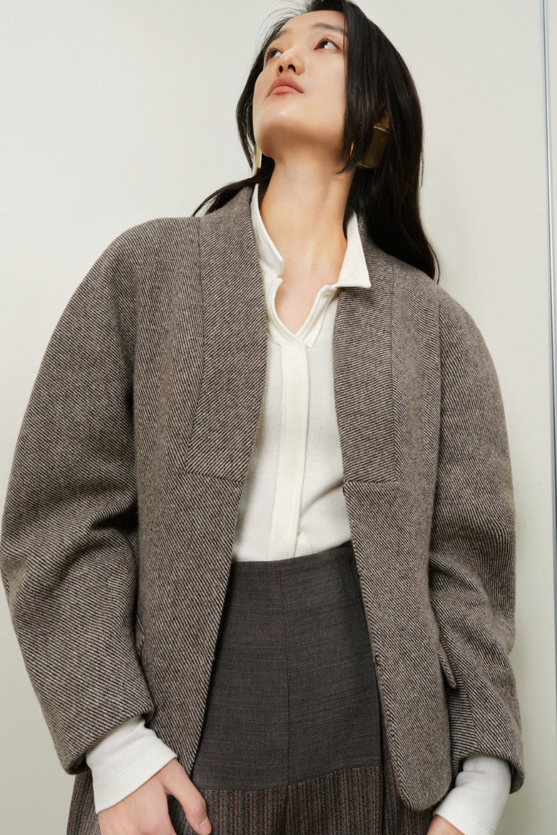 Light blue boxy collarless jacket by LECIA, featuring a modern, minimalist design and clean lines, displayed on a neutral background.