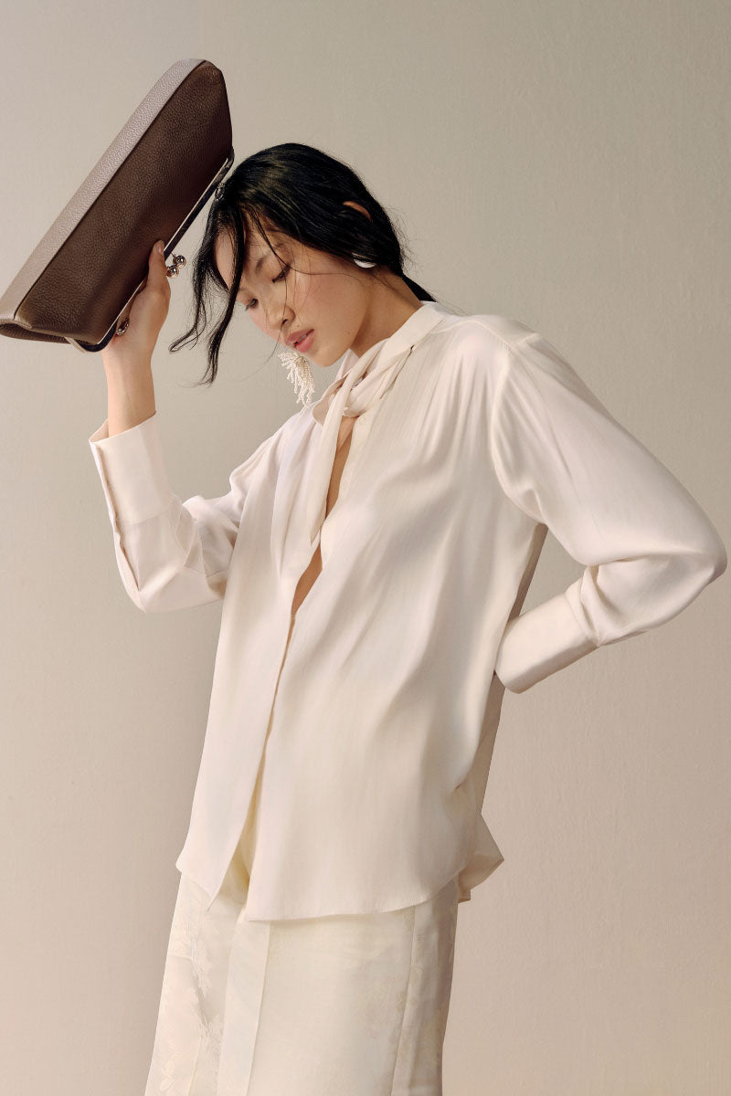 Ivory satin twilly shirt by Lecia featuring a sleek, smooth fabric and stylish collar design.
