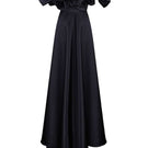 Black Monetre corset gown with meringue flounces, elegant floor-length dress featuring ruffled details and fitted bodice.