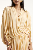 Deme By Gabriella gold maxi dress with elegant flowy fabric and fitted waist, perfect for formal or summer occasions.