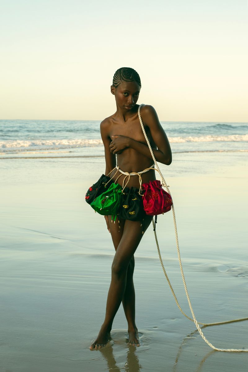 Waiwai Rio BEL CETIM cherry top handle bag with a sleek, glossy finish and elegant design, featuring a structured silhouette.