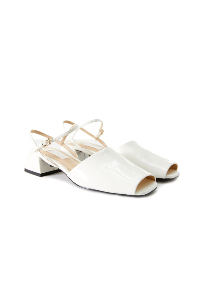Chictopia ivory peep toe slingback heels sandals with open toe and strap detail on a stylish model.