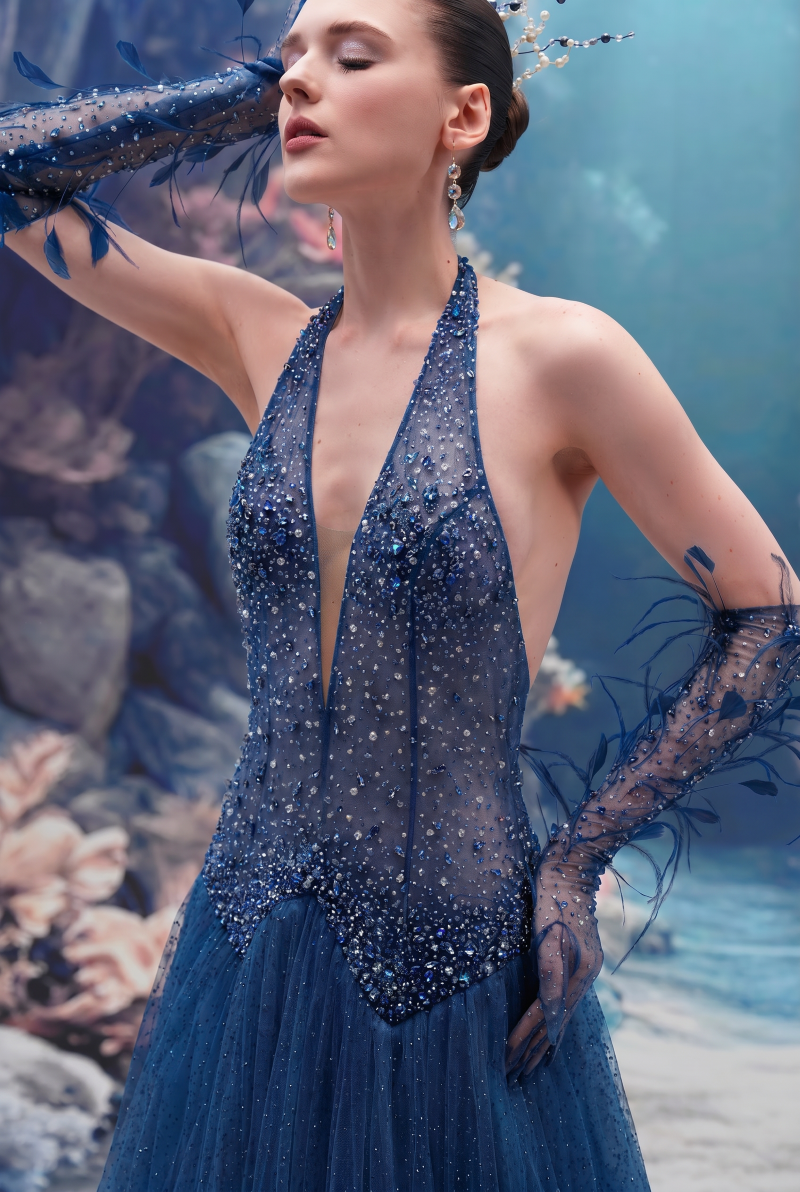 Dark blue Muriel glitter tulle gown by 21Six with matching gloves, featuring a flowing design and shimmering fabric.