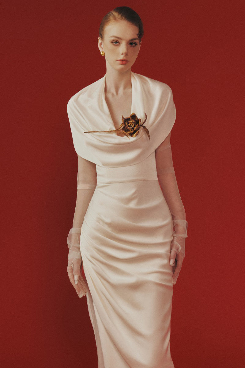 Margée Atelier Celina Maxi Dress displayed on a hanger, featuring flowing fabric and elegant design for stylish summer wear.