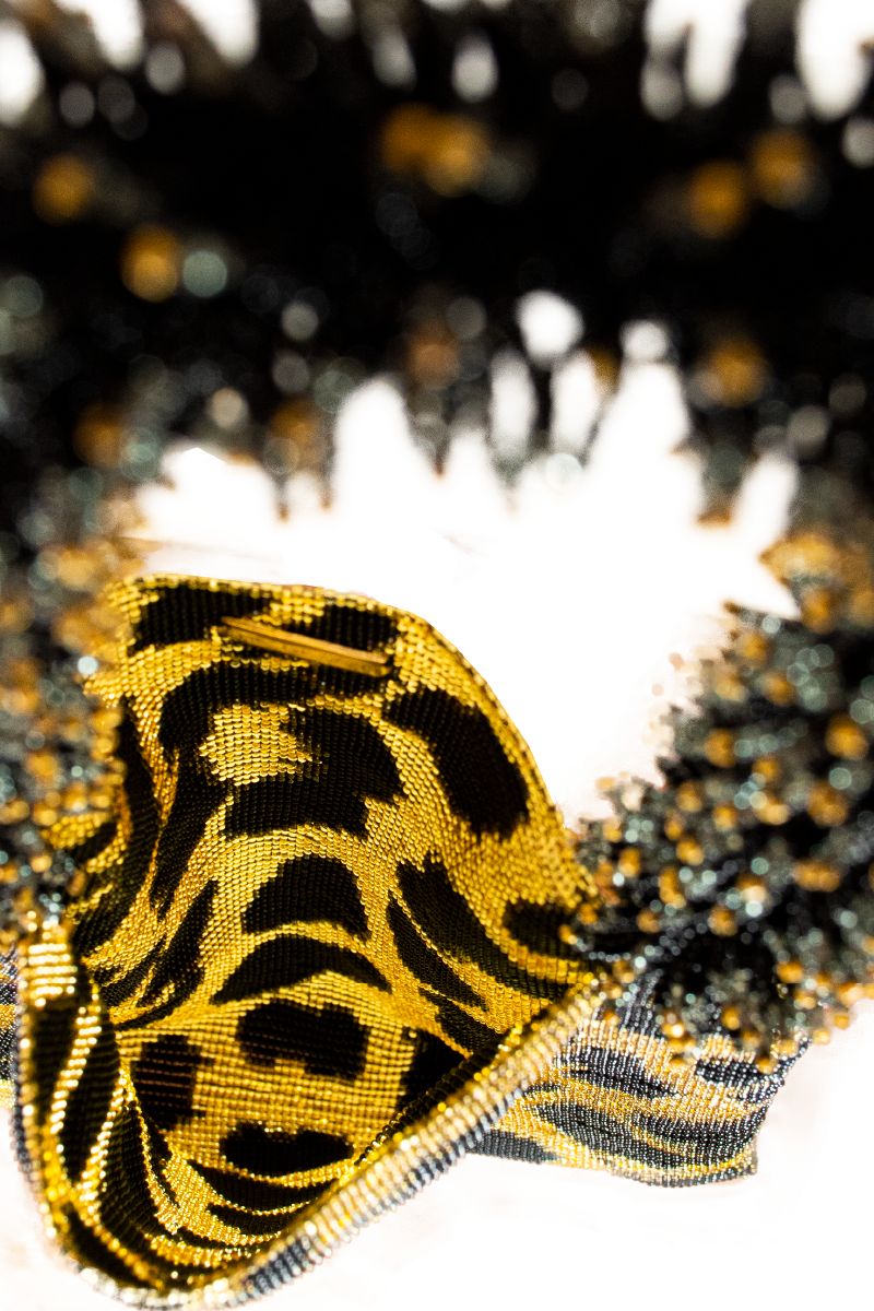 SAC DE SOUL leopard print black and gold shoulder bag with gold chain strap and bold print design.