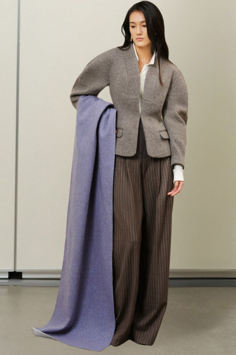 Light gray boxy collarless jacket from Lecia, featuring a modern, minimalist design with a clean neckline and tailored fit.