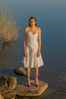 Liya white sweetheart top with a fitted bodice and delicate straps, showcased on a flat lay with soft fabric background.