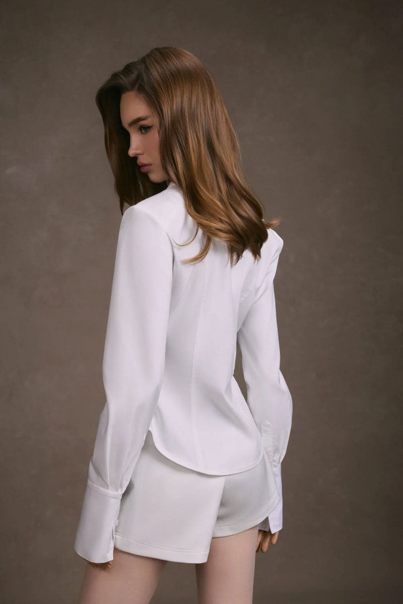 White cupped collar shirt by KEIRA TONG, featuring a stylish collar and tailored fit, displayed on a hanger.