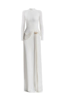 White Corvina draped floor-length gown by Maison Des Copains, elegant formal dress with flowing fabric and sophisticated style.