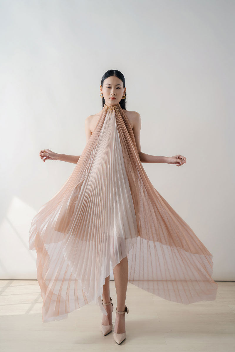 Peach pleated halter neck chiffon midi dress by DOC BAN, featuring a flowy, elegant design with pleated details and a halter neckline.