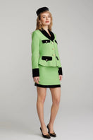 Nana Jacqueline Michelle Green Tweed Mini Skirt featuring a classic high-waisted design and textured green tweed fabric.