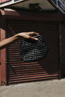 Black leather clutch by Adriana Castro, LA POPA LEATHER in sleek, minimalist design with subtle texture and elegant finish.