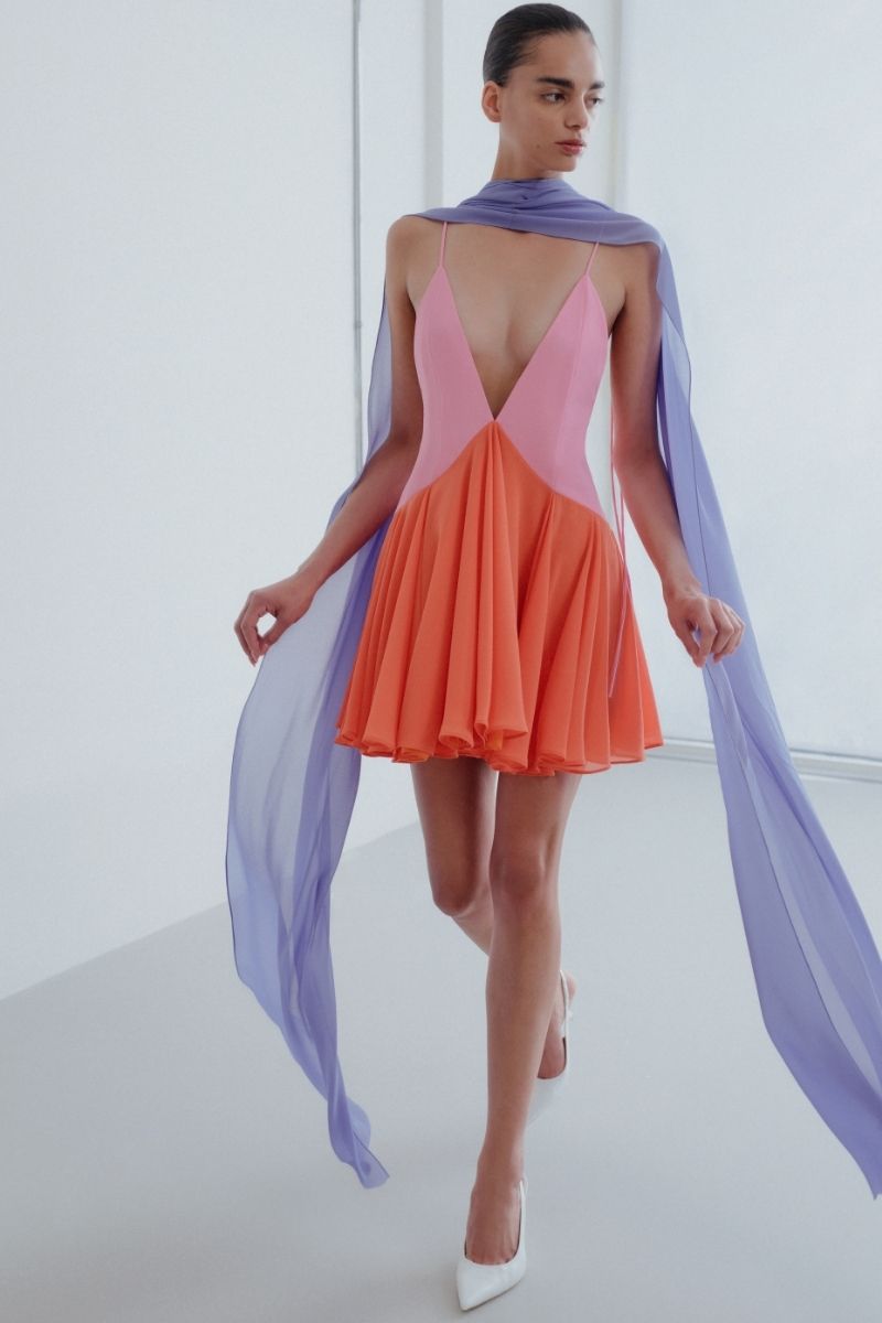 Sisters Kimberly mini dress in peachy pink, sleeveless with a fitted bodice and flared skirt, perfect for spring and summer wear.