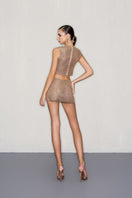 CEM gold mesh top featuring a stylish see-through design with long sleeves and a round neckline.