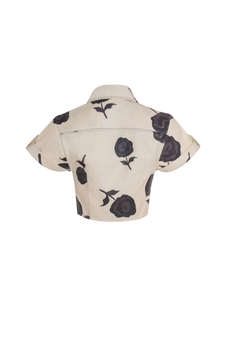 Black Rosseta blouse by Estefania, featuring ruffled details and long sleeves, displayed on a white background.