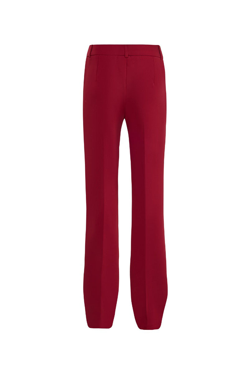 Red crepe pants by CEM with a relaxed fit and stylish design, shown on a model in a full-length view.