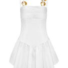 White sunny dress by Laura Escobar, mini dress style, featuring a stylish and flowy design perfect for warm weather.